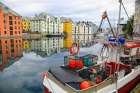 Alesund, Norway. Fishing boat and canal water reflection. Art Print